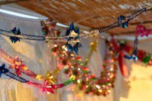 Colorful Sukkah decoration shiny garland at sunset light.