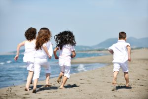 kids in white on the beach